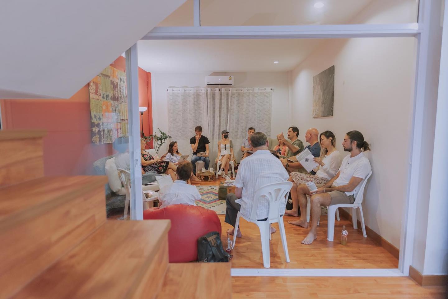 A group seated in rows during a workshop in the upstairs meeting room